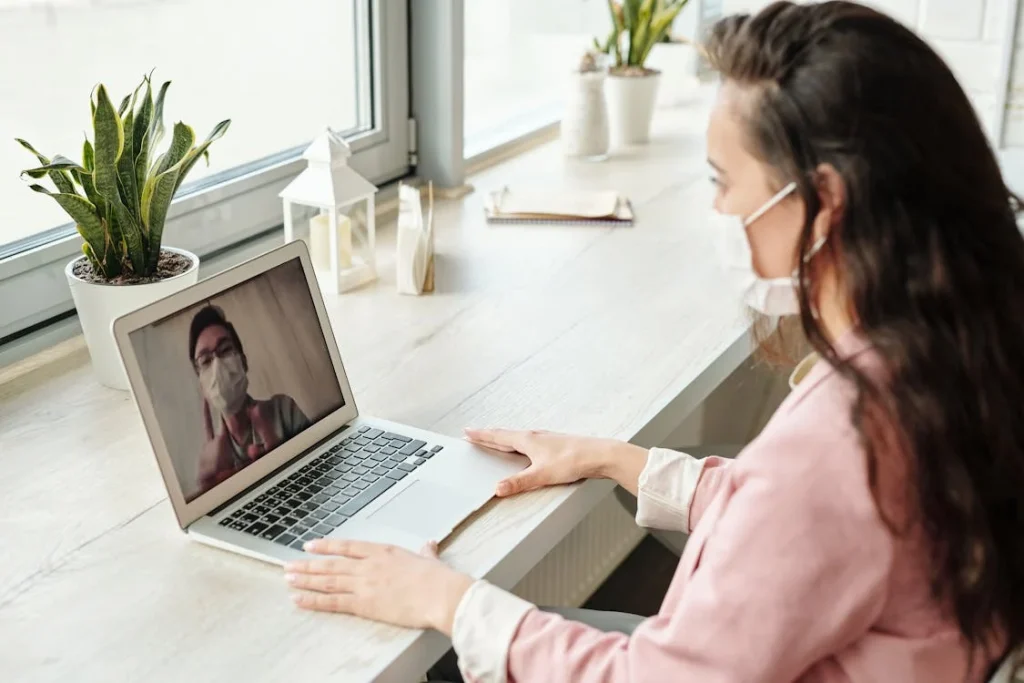 A woman on a video call at her desk at home