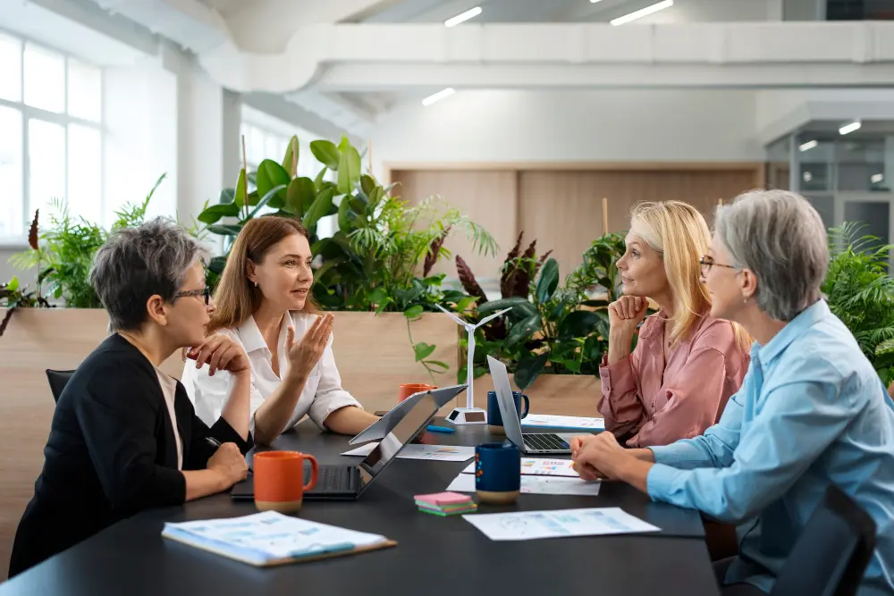 Four colleagues in a meeting around a conference table